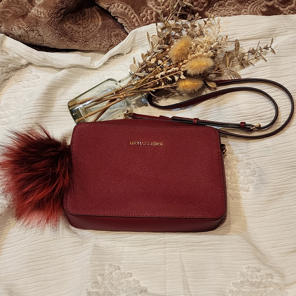 Burgundy Michael Kors crossbody purse.